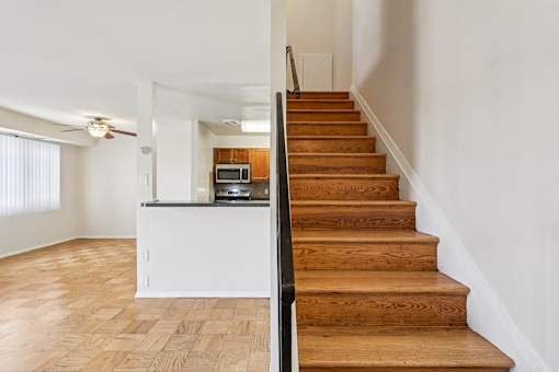 A staircase leads up to a kitchen area.