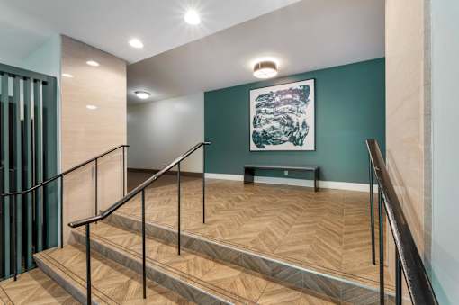 A staircase with a wooden floor and metal handrails.