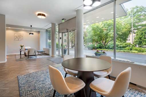 A dining area with a table and chairs.
