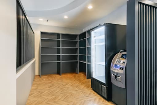 A modern room with a vending machine on the right side.