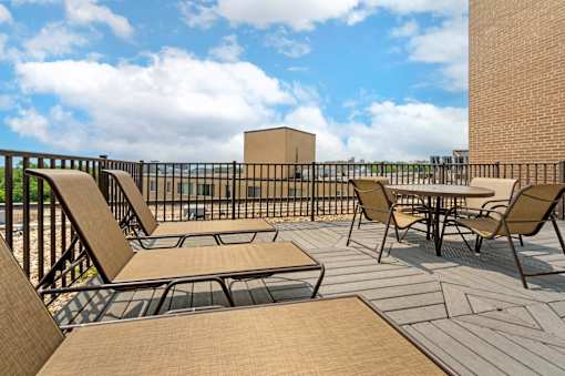A patio with chairs and a table.
