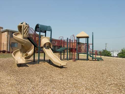 A playground with a slide, swings, and a climbing frame.