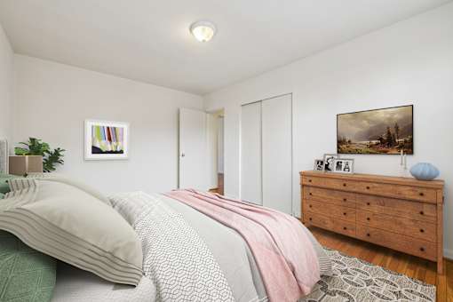 A bedroom with a bed, dresser, and painting on the wall.