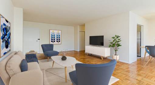 A living room with a white sofa, blue chairs, and a television.