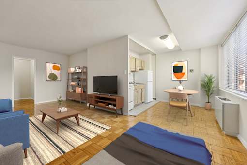 A living room with a blue couch, a wooden coffee table, a television, a refrigerator, and a potted plant.