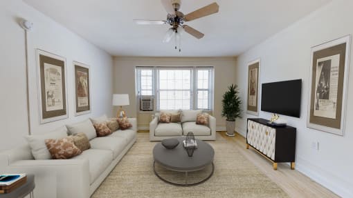 living area with sofa, coffee table, large windows, and ceiling fan at the calverton apartment building in washington dc