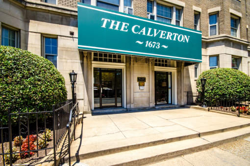 exterior entrance of stone apartment building called the calverton in washington dc