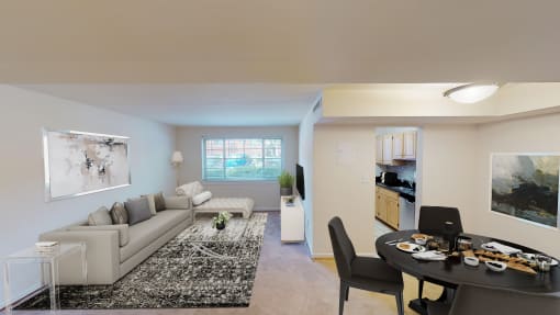 living area with sofa, coffee table, large windows, and views of kitchen and dining areas at cambridge square apartments in bethesda md