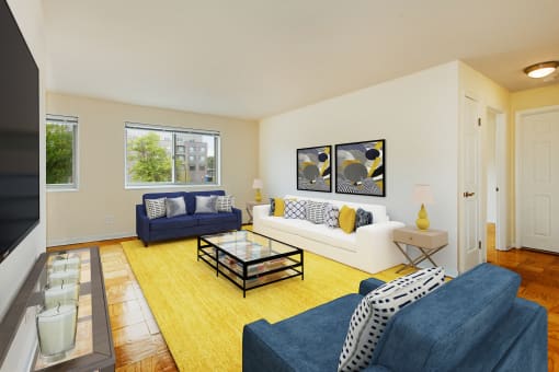 living area with large windows, sofa, love seat and coffee table at chillum place apartments in washington dc