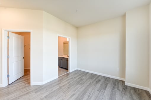 vacant bedroom with hardwood floors and view of bathroom at city view apartments in washington dc