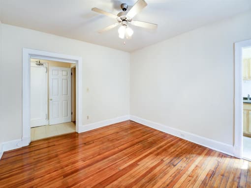 vacant living area with hardwood flooring and ceiling fan at 315 Mount Pleasant apartments in washington dc