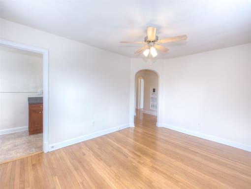vacant living area with hardwood flooring and ceiling fan at 6100 14th Street apartments in washington dc