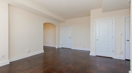 vacant living area with hardwood flooring, coat closets and view of front entrance at juniper courts apartments in takoma washington dc