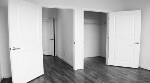 vacant bedroom with large closets and hardwood flooring at sheridan station apartments in washington dc