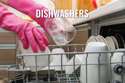 A person in pink gloves is loading dishes into a dishwasher.