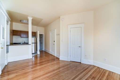 vacant living area with hardwood floors and view of breakfast bar in kitchen at dupont apartments in washington dc
