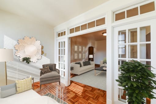 living area with sofa, coffee table, hardwood floors and view of sunroom at eddystone apartments in washington dc