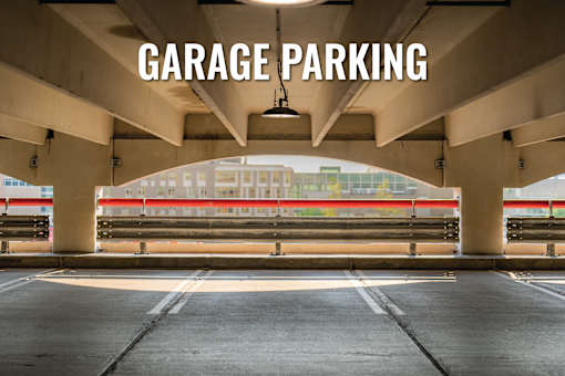 Garage parking with a view of a building in the background.