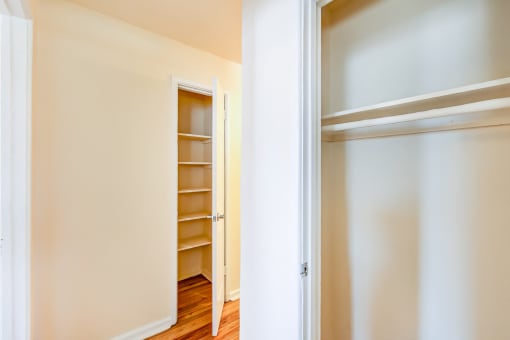 bedroom closet with shelving and view of hallway closet at garden village apartments in congress heights washington dc