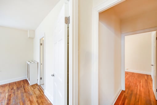 vacant apartment with hardwood floors and view of living and bedroom areas at hampton courts apartments in washington dc