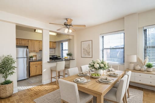 A dining room with a table set for a meal.