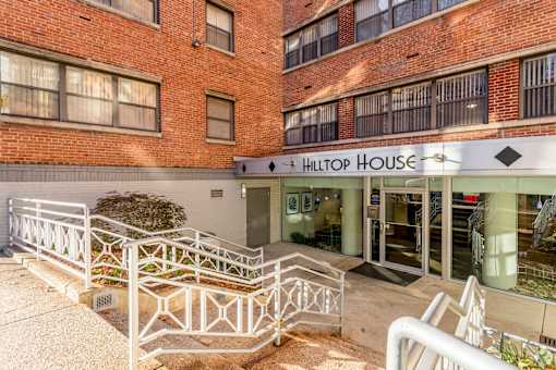 The entrance to the Hilton House building with a white railing in front.