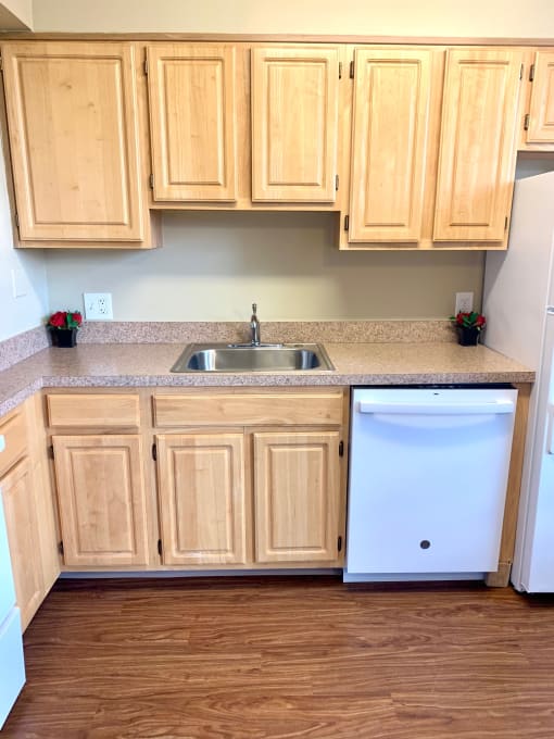 kitchen with oak cabinetry and dish washer at 3101 Pennsylvania apartments in Washington dc