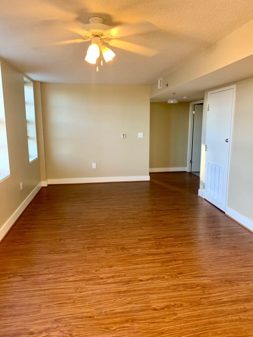 vacant living area with hardwood floorings, ceiling fan, and large windows at 3010 Pennsylvania Washington dc