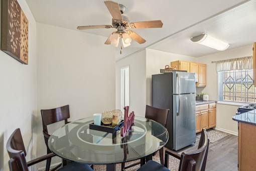 A dining room with a glass table and chairs.