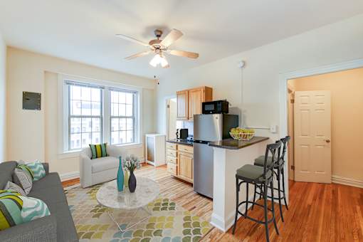 A kitchen with a bar stool and a counter.