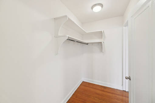 A white room with a wooden floor and a door.