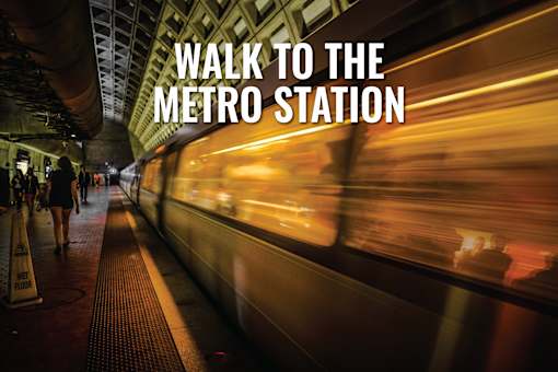 A train is passing by a subway station platform.
