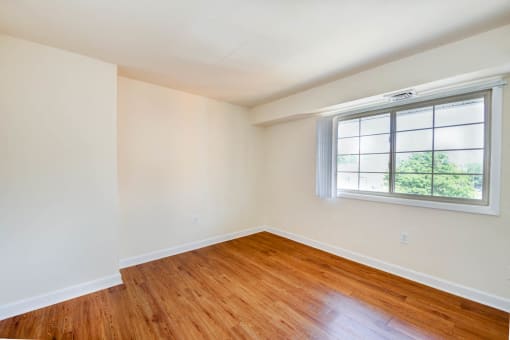 bedroom with window and wood flooring at naylor overlook apartments in skyland washington dc