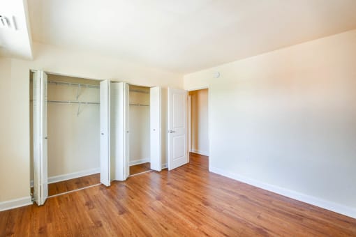 bedroom with large closets and hardwood flooring at naylor overlook apartments in skyland washington dc