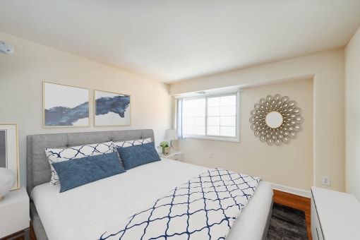 bedroom with bed, nightstand, hardwood flooring and window at naylor overlook apartments in washington dc