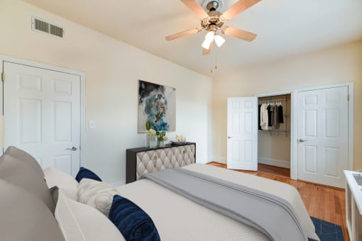 bedroom with bed, dresser, large closet, ceiling fan and hardwood floors at the norwood apartments in adams morgan washington dc