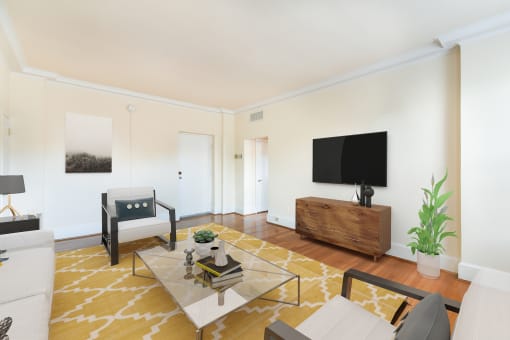 living area with sofa, coffee table, credenza, tv, hardwood floor and view of front entrance at the norwood apartments in adams morgan washington dc