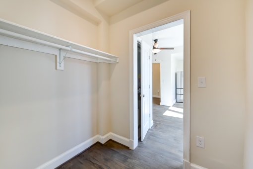 walk in closet with large shelf and wood flooring at petworth station apartments in washington dc