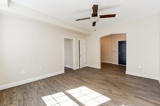 vacant living area with wood flooring and ceiling fan at petworth station apartments in washington dc