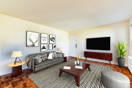 living area with sofa, coffee table, ottoman, credenza and tv at the richman apartments in congress heights washington dc