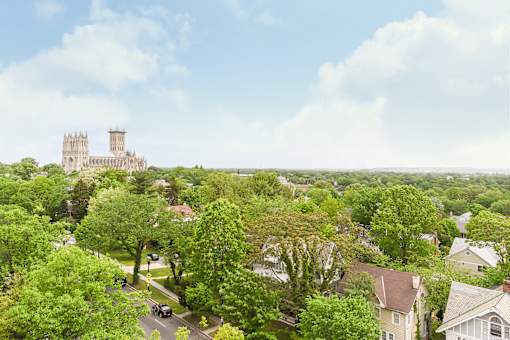 A castle sits atop a hill overlooking a residential neighborhood.