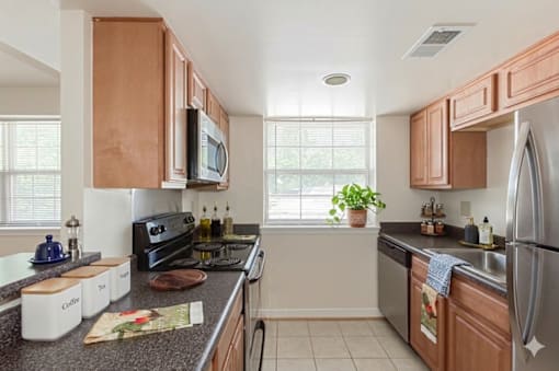 A kitchen with wooden cabinets and a black stove top oven.
