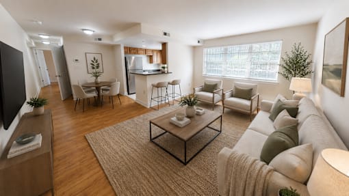 A modern living room with a large sofa, a coffee table, and a television.