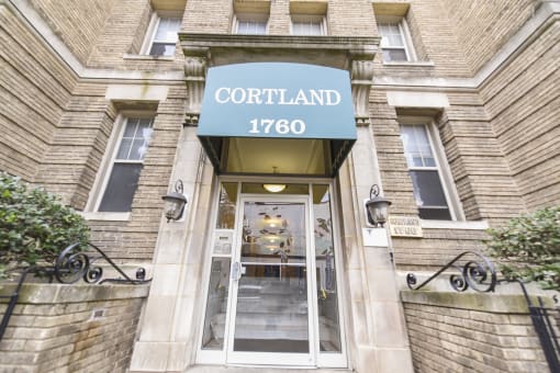 entrance of cortland apartments with green awning in washington dc