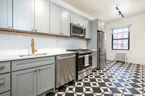 A kitchen with a black and white checkered floor.