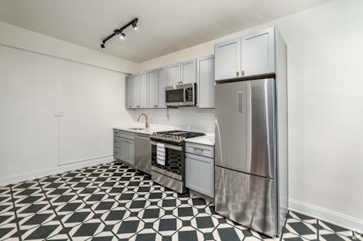 A kitchen with a black and white checkered floor.