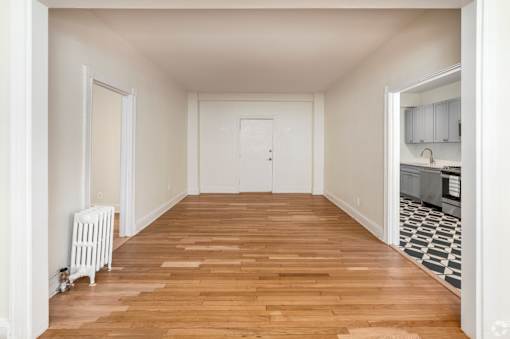 A room with wooden floors and white walls.