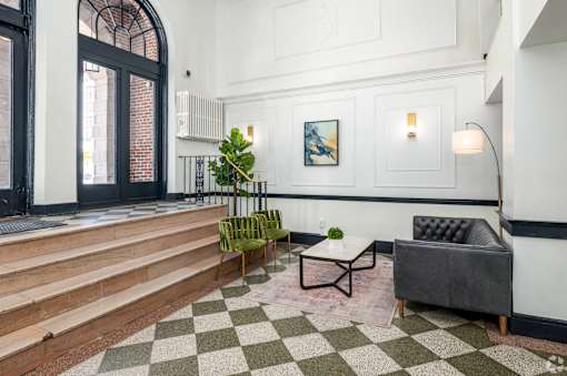 A living room with a black and white checkered floor.