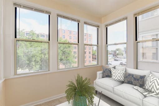 sunroom with sofa, coffee table and large windows at twin oaks columbia heights washington dc