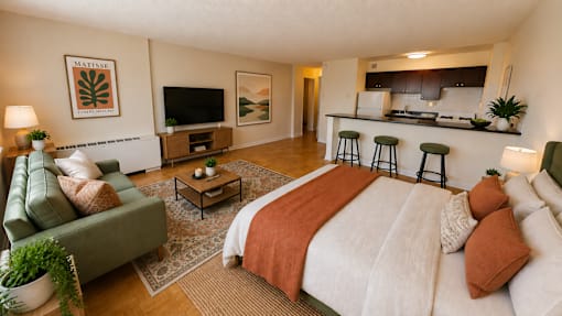 A bedroom with a large bed and a couch.